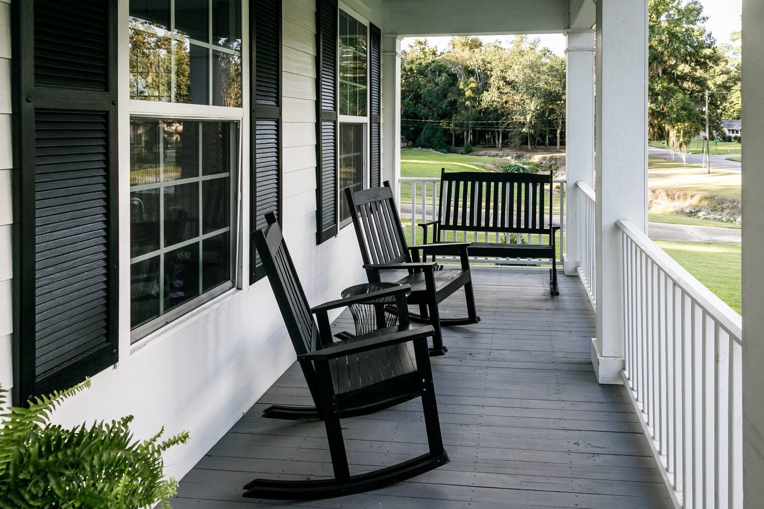 A stylish white wooden front porch built by porch builders Mount Prospect team